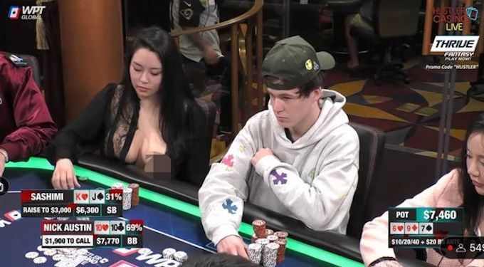 Sashimi Poker in a bodysuit and fake breasts during a Hustler Casino Live game.